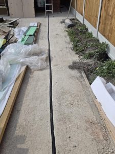 Solar PV cable route passing through the side passage of a residential property in Ilford